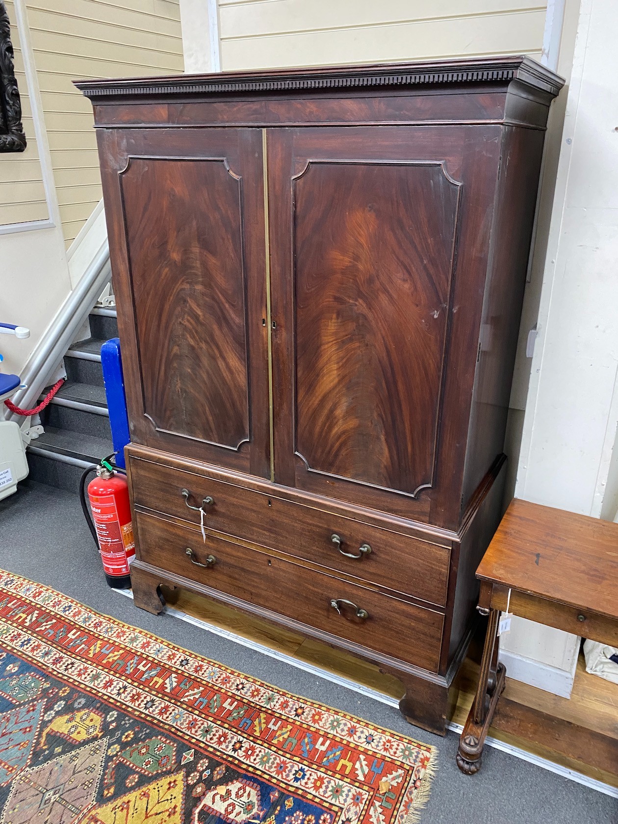 A George III mahogany linen press fitted slides, length 125cm, depth 60cm, height 186cm